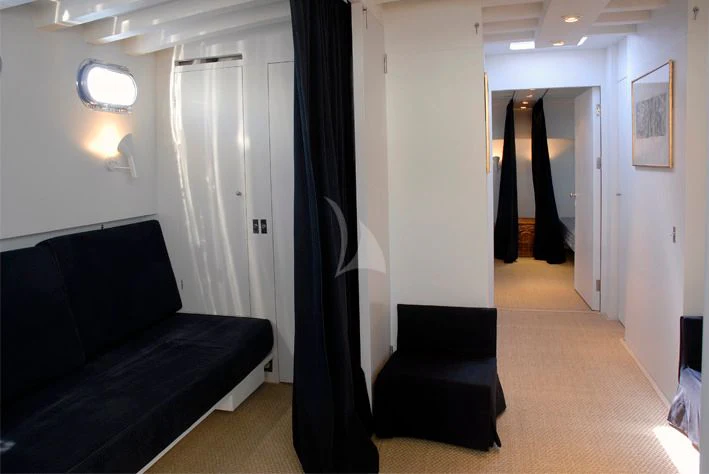 a room with a couch and a door aboard LA MER Yacht for Sale