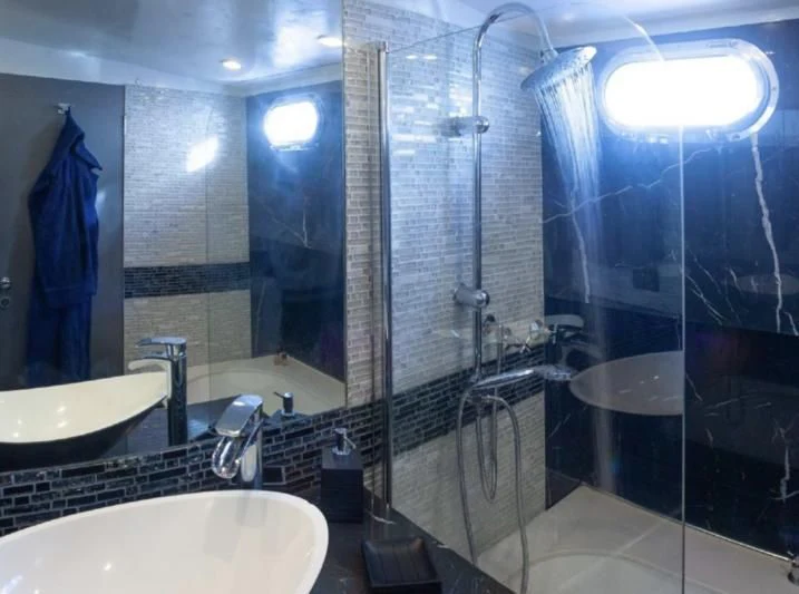 a bathroom with a glass shower aboard LA MER Yacht for Sale