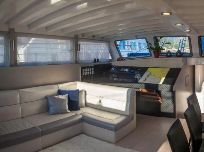 a room with a couch and a television aboard LA MER Yacht for Sale