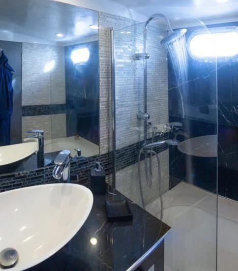 a bathroom with a sink and a shower aboard LA MER Yacht for Sale