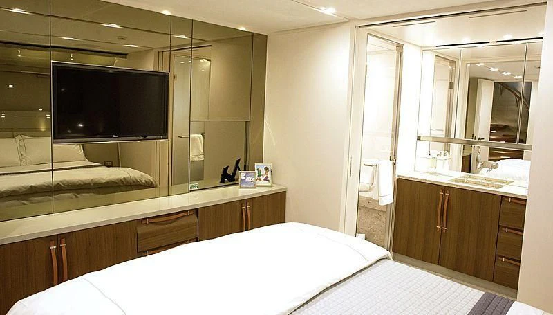 a room with a bed and a tv aboard R&R Yacht for Sale