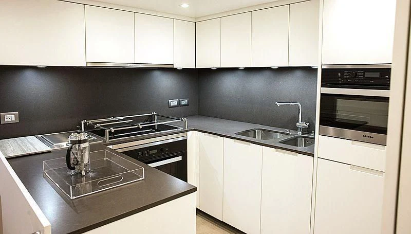 a kitchen with white cabinets aboard R&R Yacht for Sale