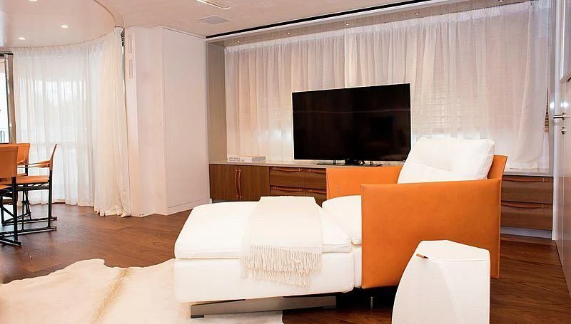 a living room with a large television aboard R&R Yacht for Sale