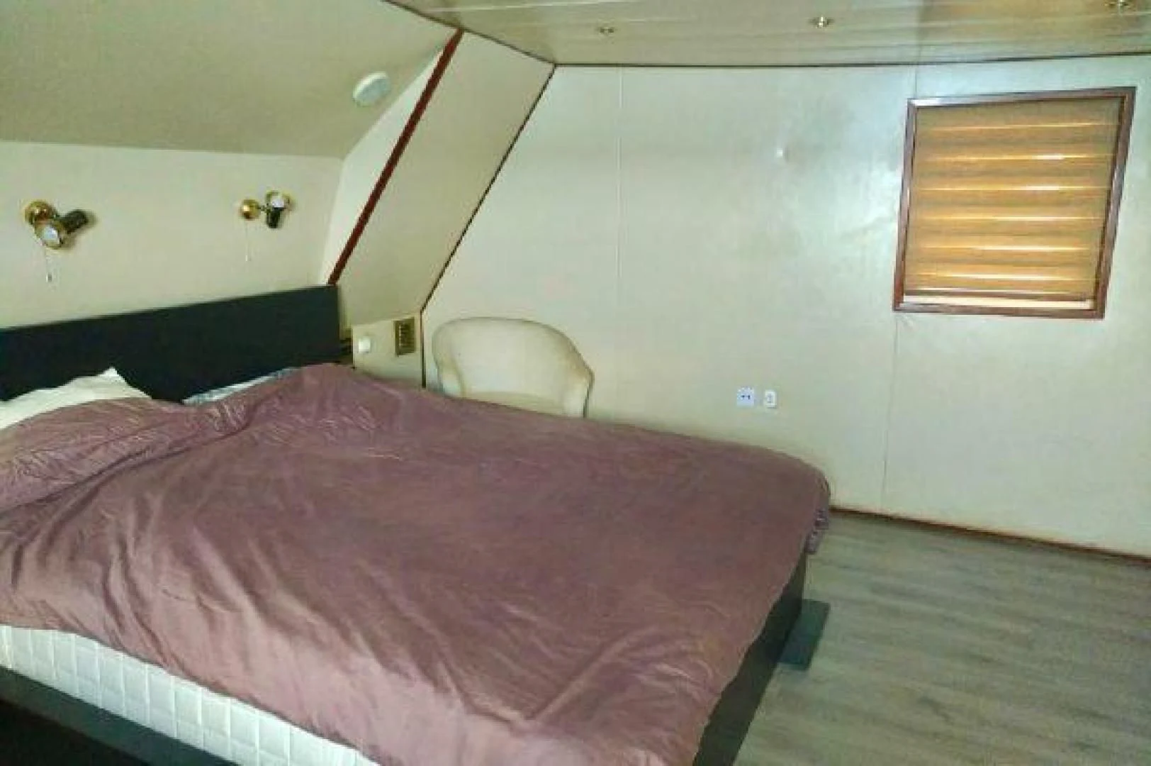 a bed with a pink comforter aboard STAR ALLIANCE Yacht for Sale