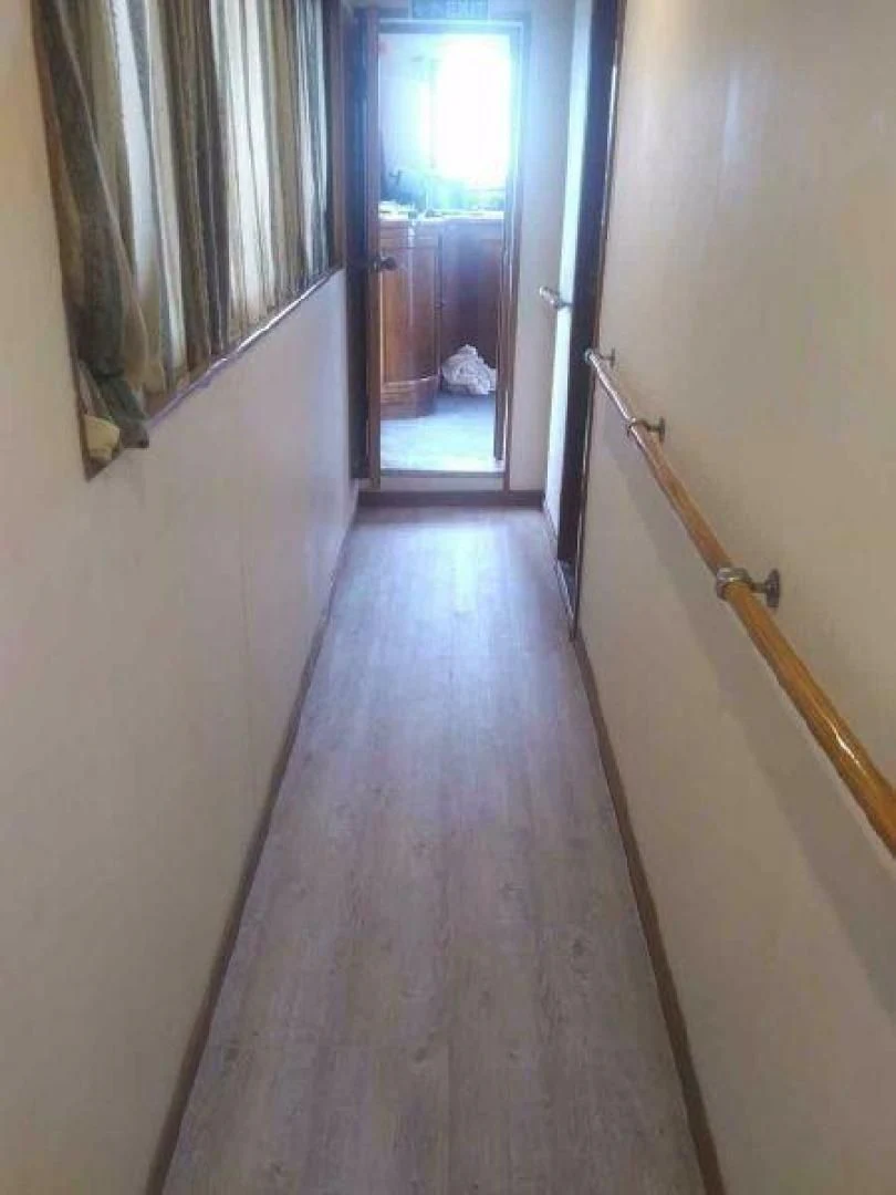 a hallway with a door and a window aboard STAR ALLIANCE Yacht for Sale