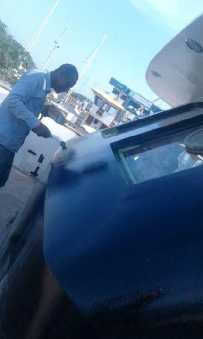 a person cleaning a car aboard STAR ALLIANCE Yacht for Sale