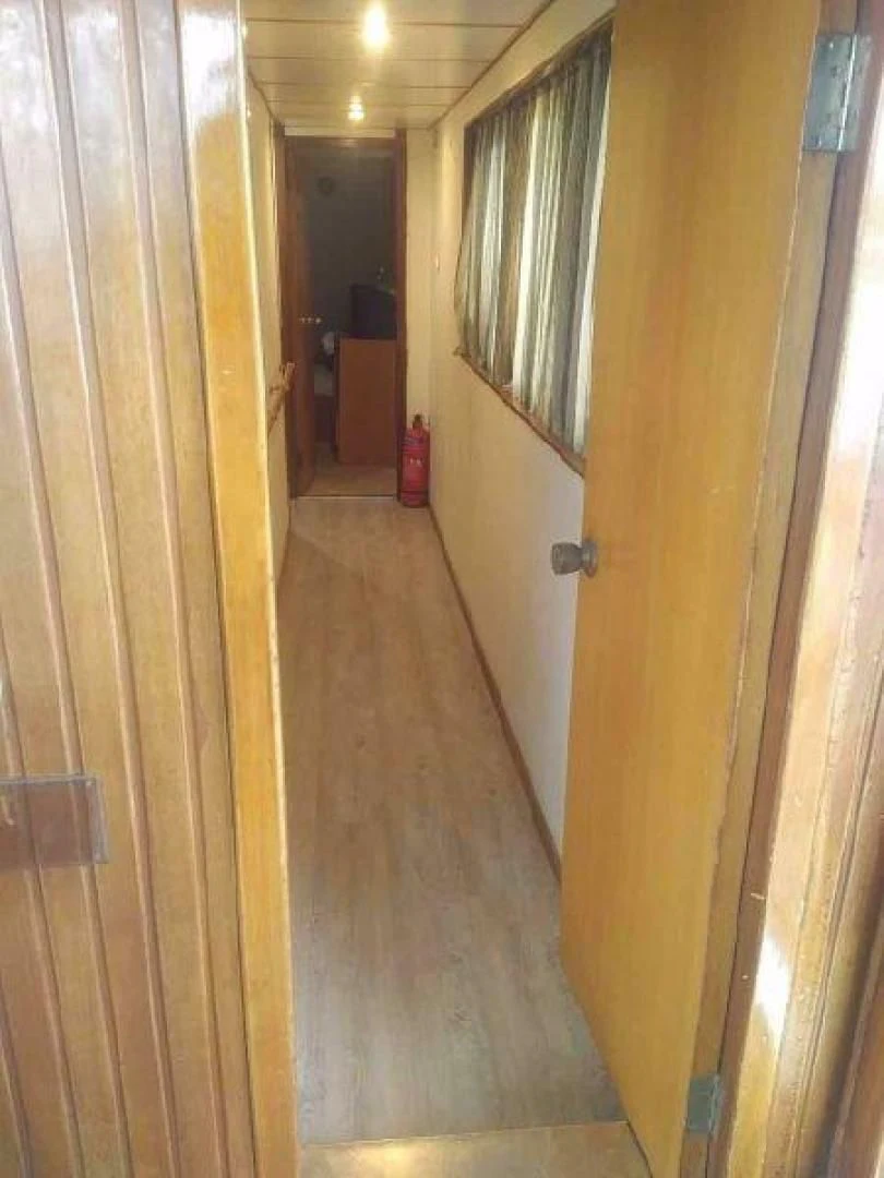 a hallway with a door and a window aboard STAR ALLIANCE Yacht for Sale
