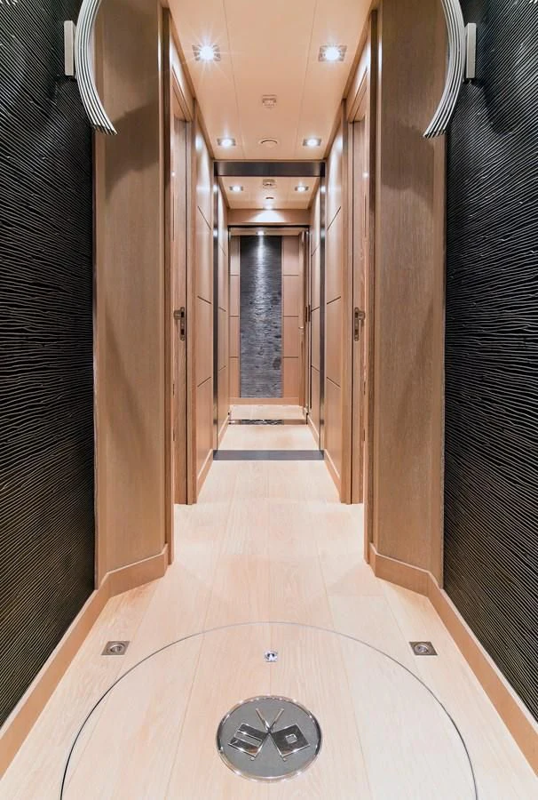 a hallway with a round window aboard AK ROYALTY Yacht for Sale