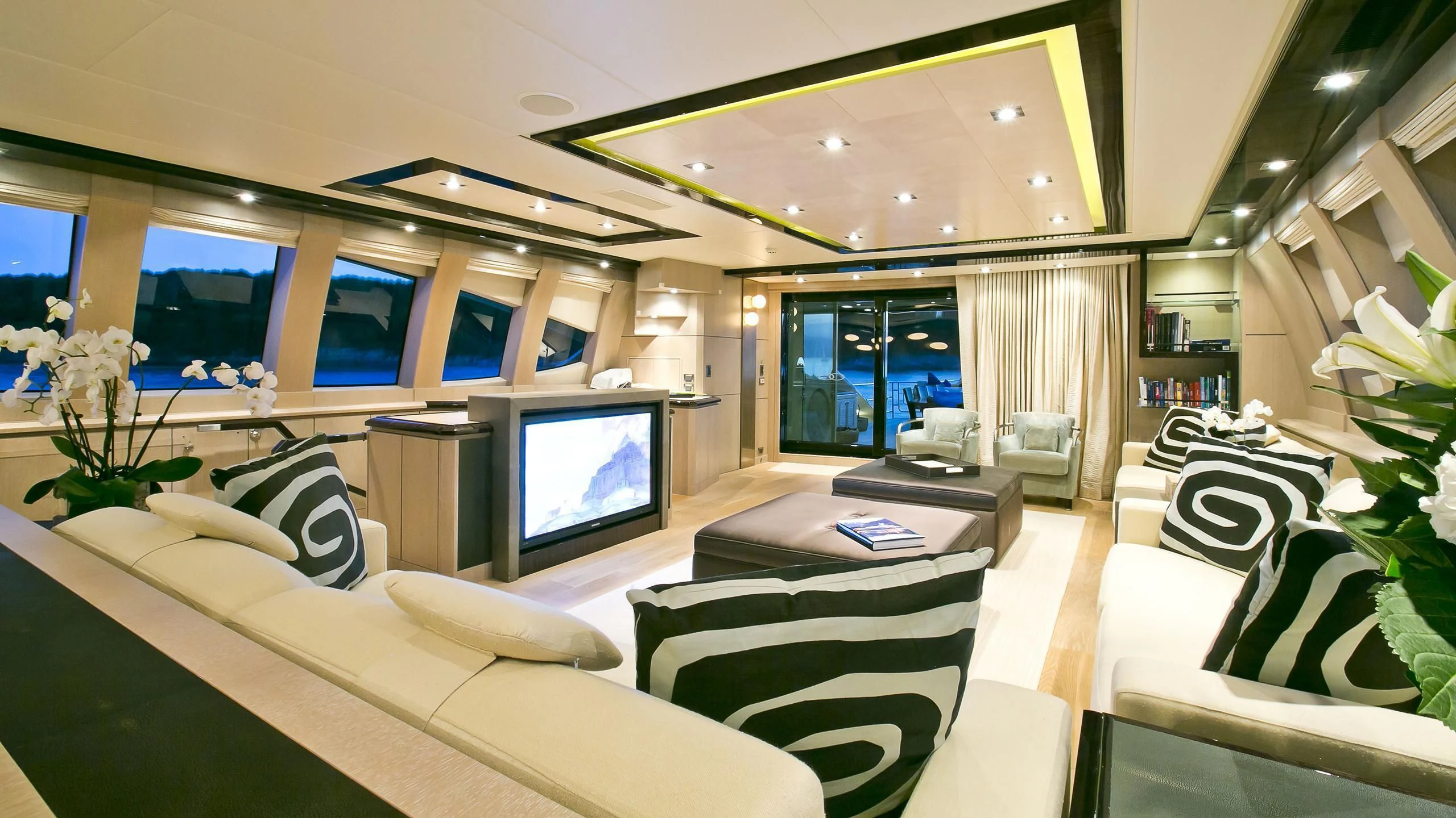 a room with a large screen tv and a couch aboard AK ROYALTY Yacht for Sale