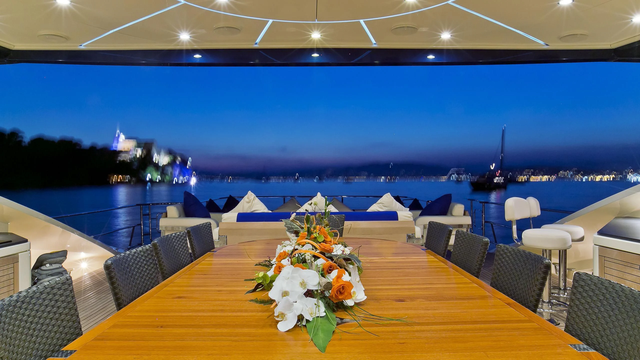 a large room with a table and chairs and a large body of water aboard AK ROYALTY Yacht for Sale