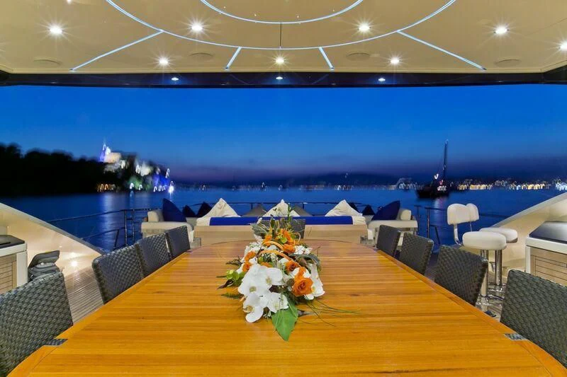 a large room with tables and chairs aboard AK ROYALTY Yacht for Sale