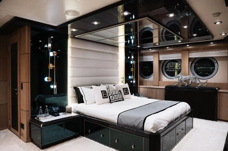 a room with a bed and a mirror aboard AK ROYALTY Yacht for Sale