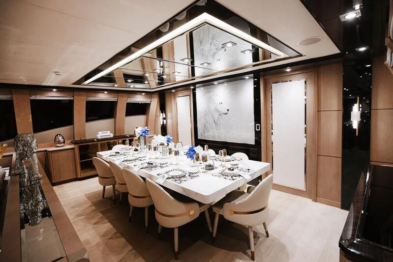 a room with a table and chairs aboard AK ROYALTY Yacht for Sale