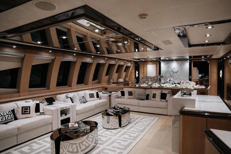 a large room with a couch and a table aboard AK ROYALTY Yacht for Sale