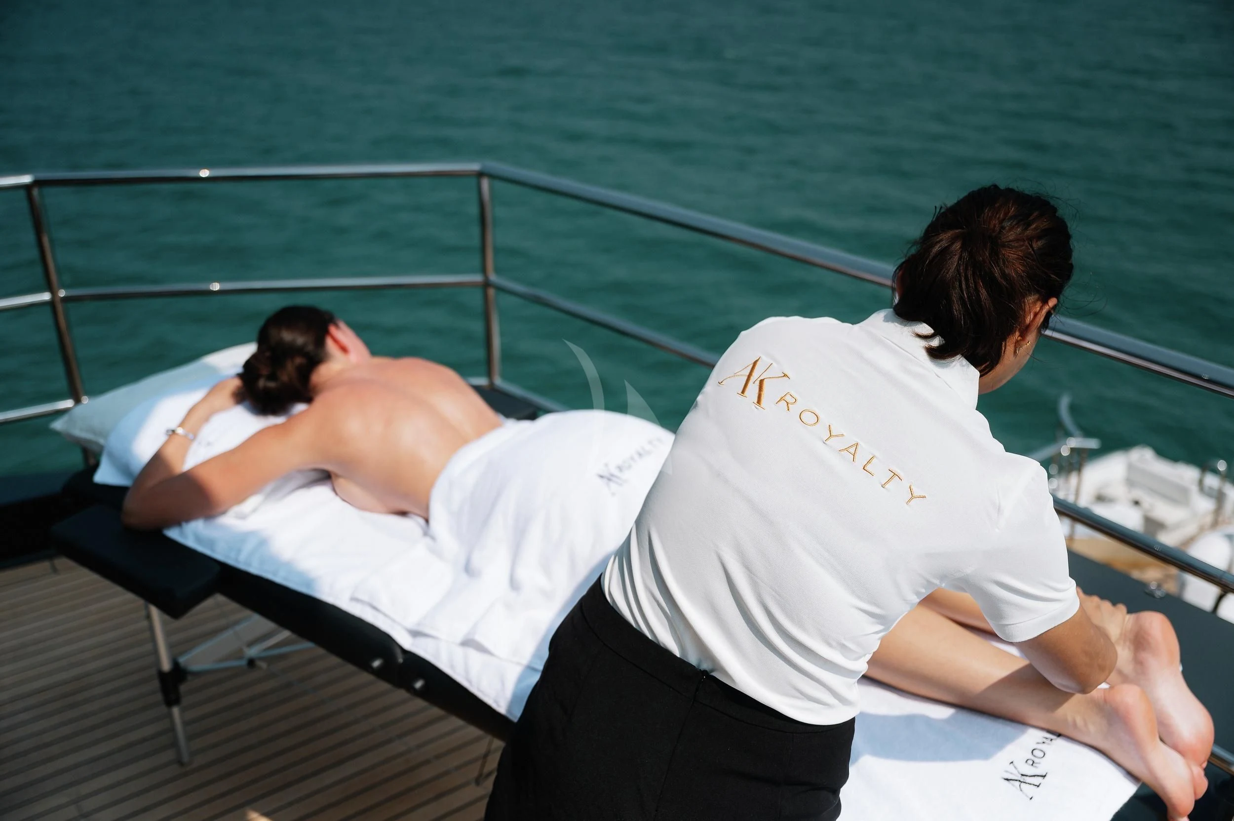 a man and woman kissing on a boat aboard AK ROYALTY Yacht for Sale