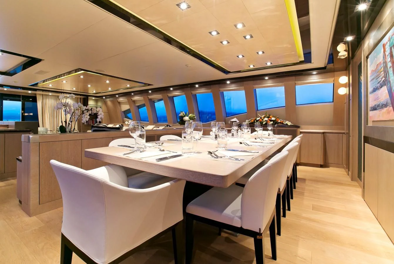 a table with wine glasses on it aboard AK ROYALTY Yacht for Sale