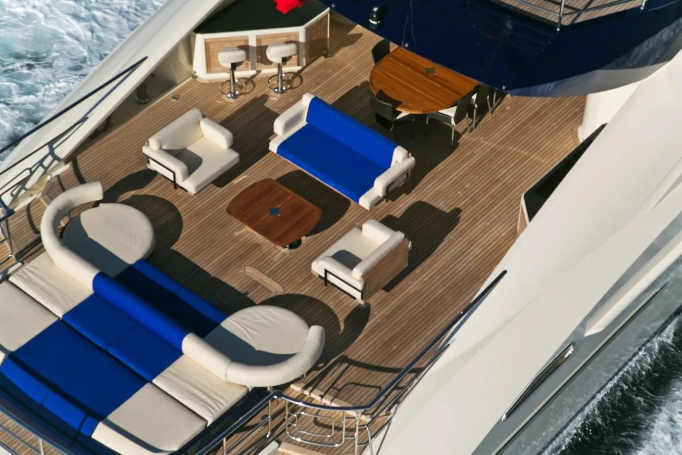 a pool with a deck and chairs aboard AK ROYALTY Yacht for Sale