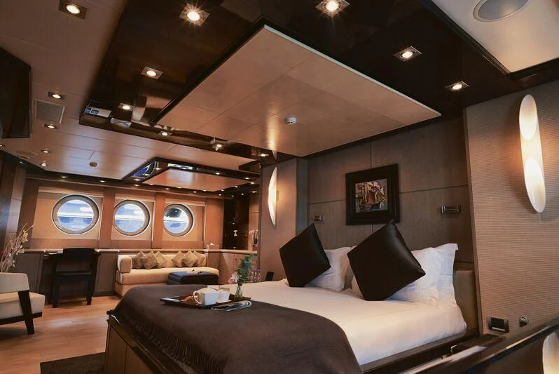 a large bedroom with a bed and a couch aboard AK ROYALTY Yacht for Sale