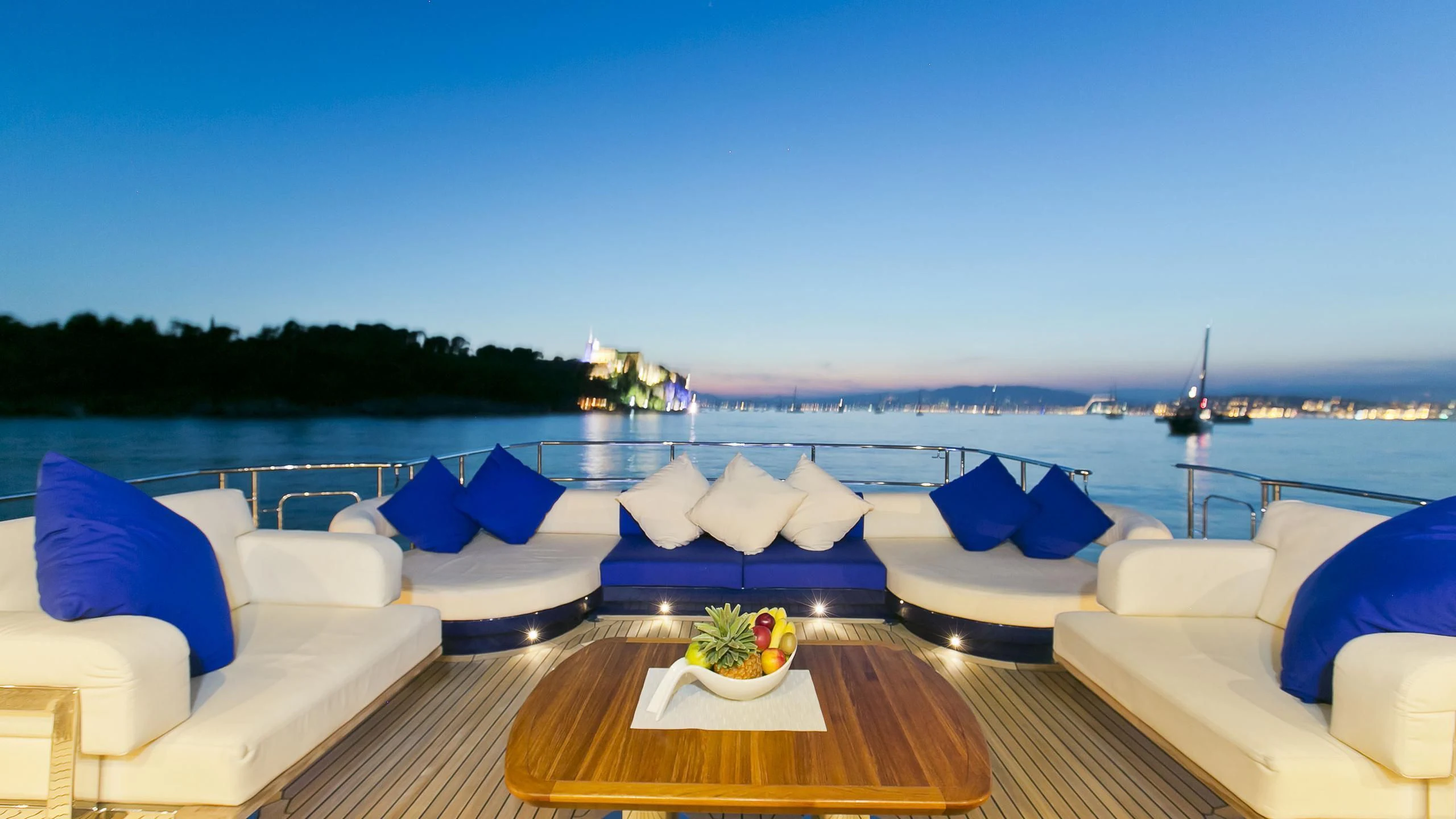 a pool with a table and chairs aboard AK ROYALTY Yacht for Sale