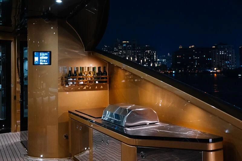a bar counter with a laptop on it aboard AK ROYALTY Yacht for Sale