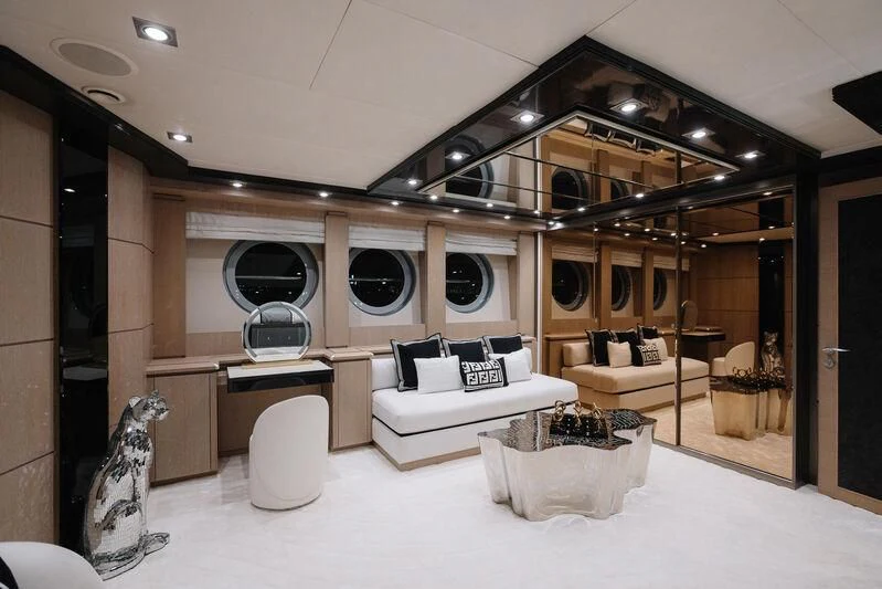 a room with a large mirror and a couch aboard AK ROYALTY Yacht for Sale