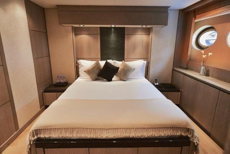 a bed with white sheets aboard AK ROYALTY Yacht for Sale
