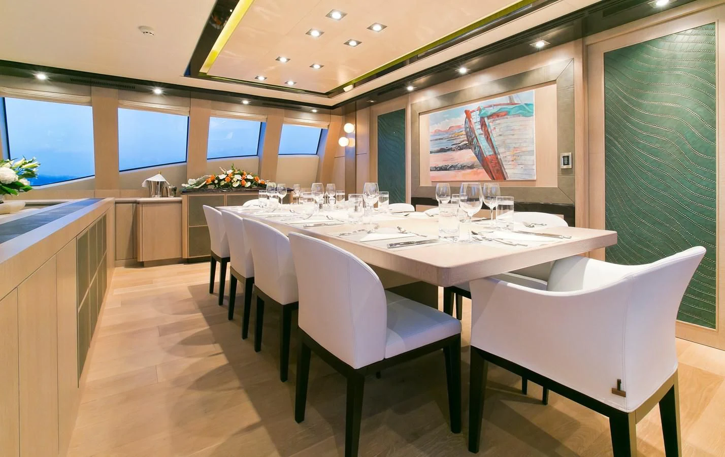 a table with chairs and a large window aboard AK ROYALTY Yacht for Sale
