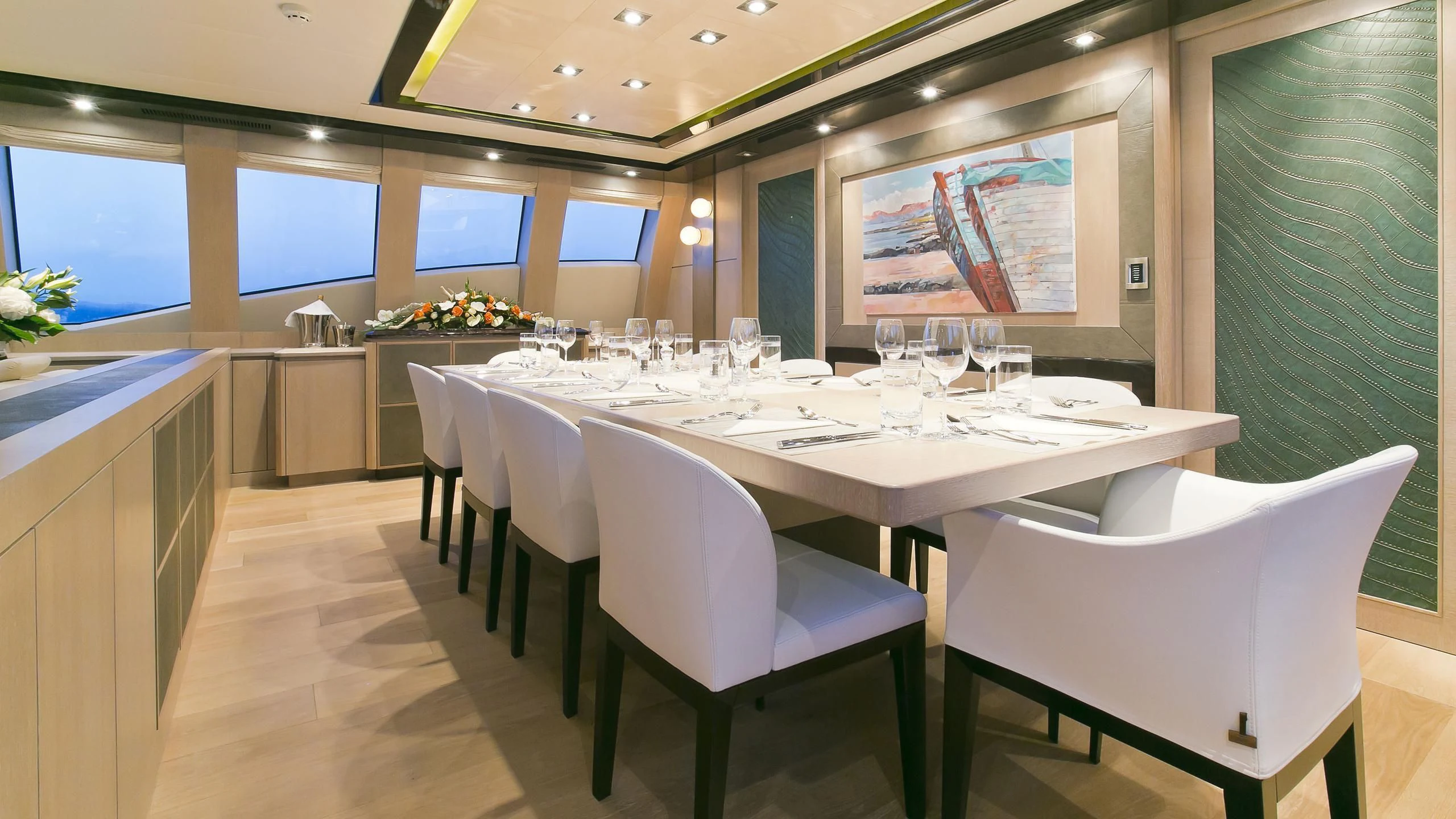 a table with chairs and a white table with white chairs aboard AK ROYALTY Yacht for Sale