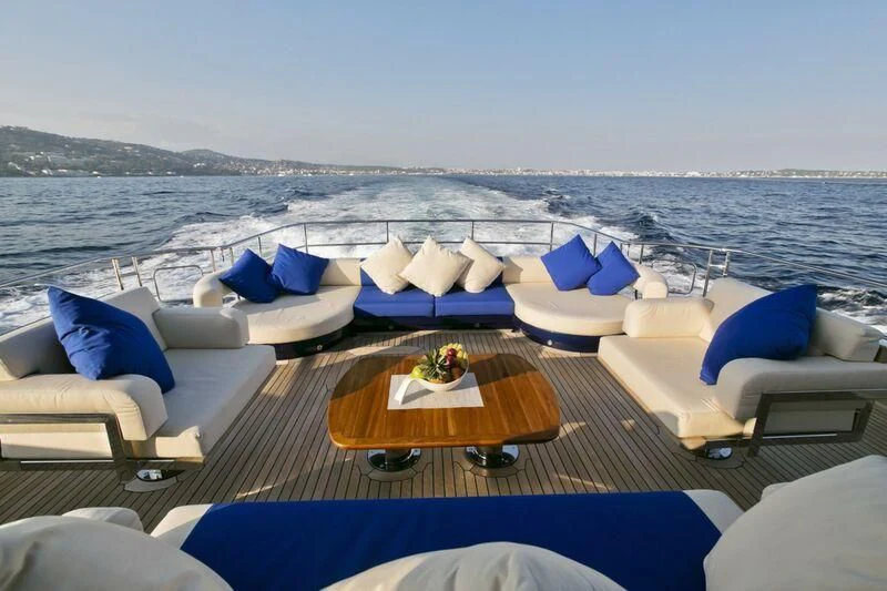 a lounge area with a table and chairs on it aboard AK ROYALTY Yacht for Sale