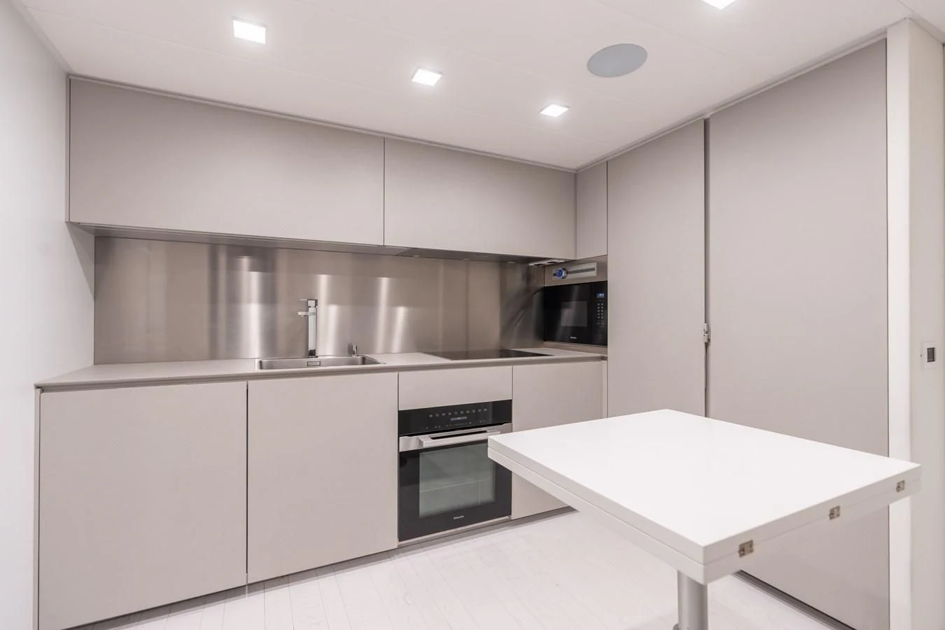 a kitchen with white cabinets aboard VINTAGE Yacht for Sale