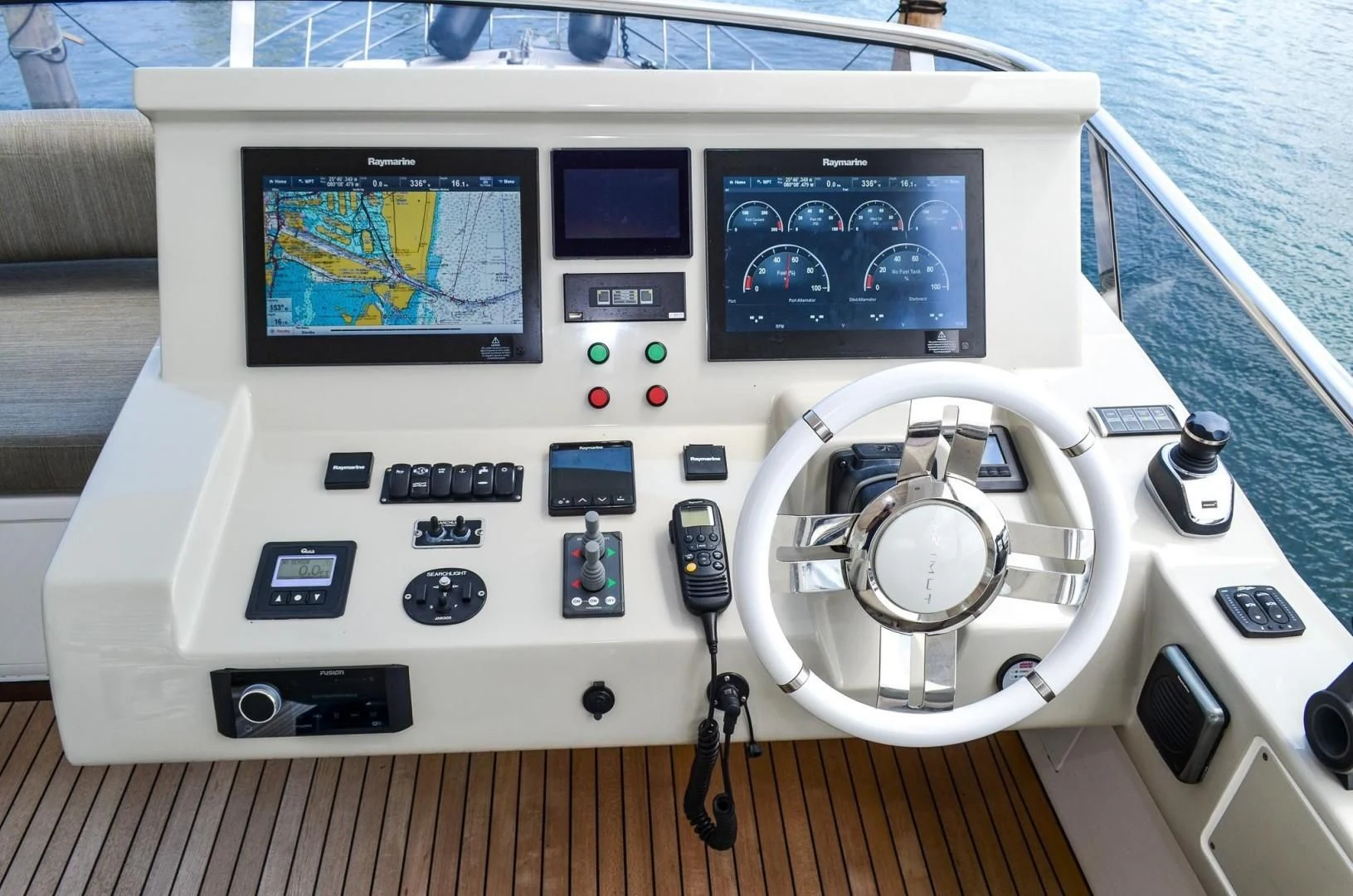 a white console with a screen and buttons and a steering wheel aboard CERULEAN Yacht for Sale