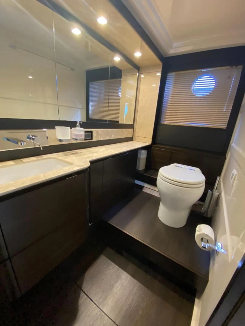 a bathroom with a toilet and a sink aboard CERULEAN Yacht for Sale