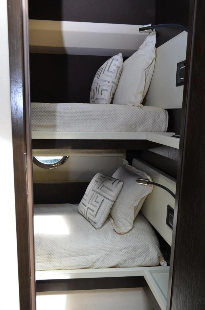 a bed with white pillows aboard CERULEAN Yacht for Sale