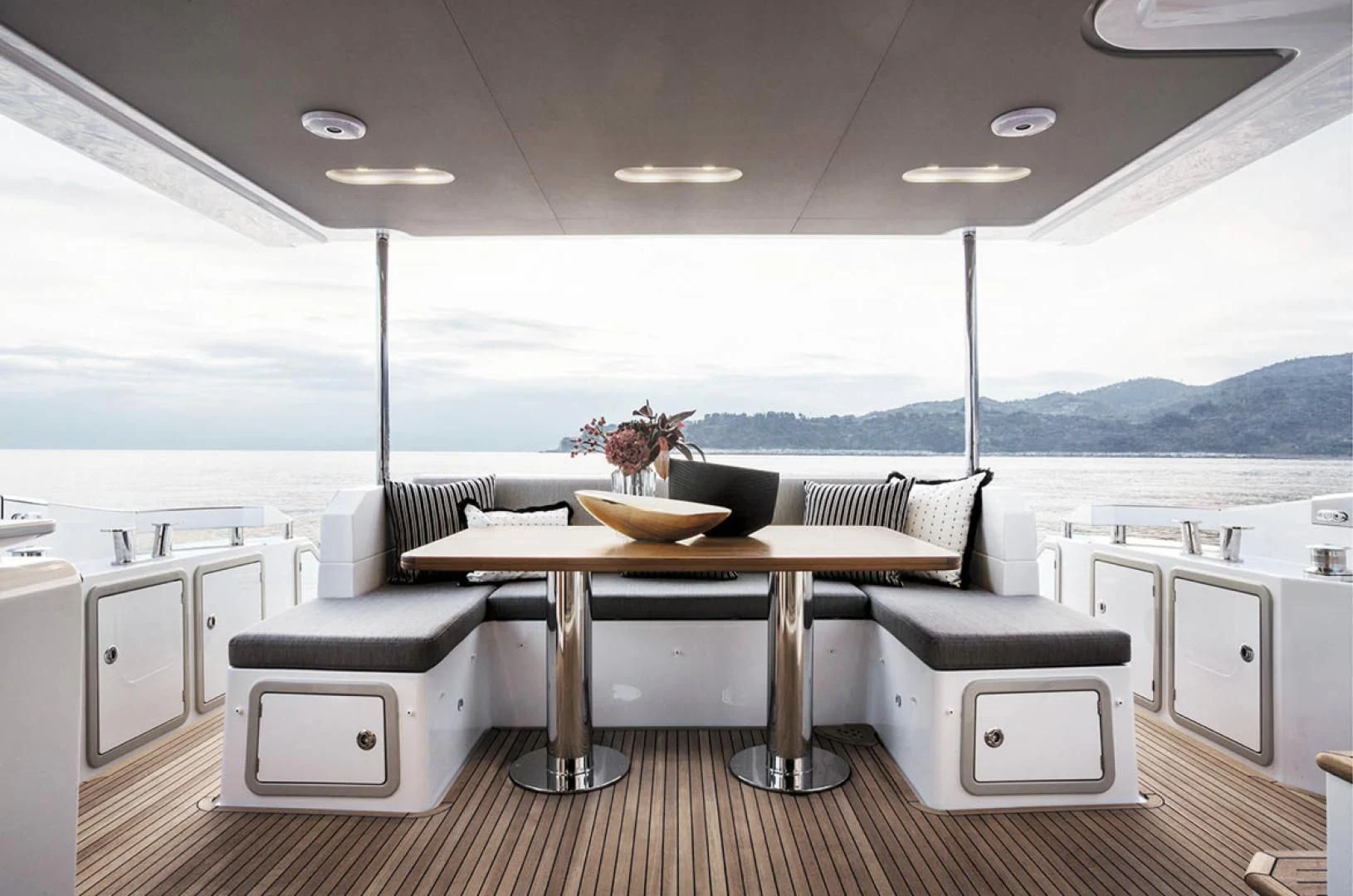 a kitchen with a table and chairs aboard CERULEAN Yacht for Sale