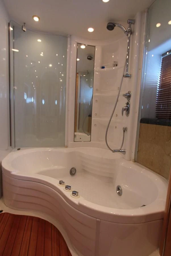 a bathtub with a shower head aboard NIKA Yacht for Sale