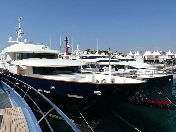 a large white boat in a harbor aboard GAJA Yacht for Sale