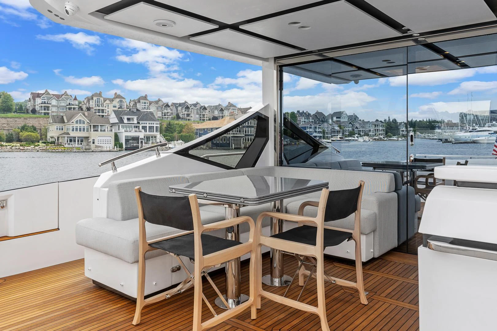 a table and chairs on a deck overlooking a body of water aboard ANONYMOUS Yacht for Sale