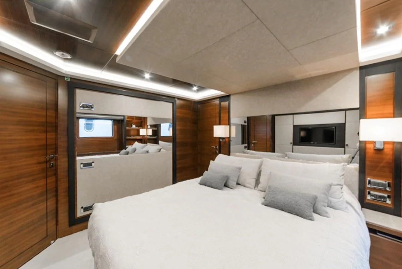 a room with a bed and a television aboard ADEL Yacht for Sale
