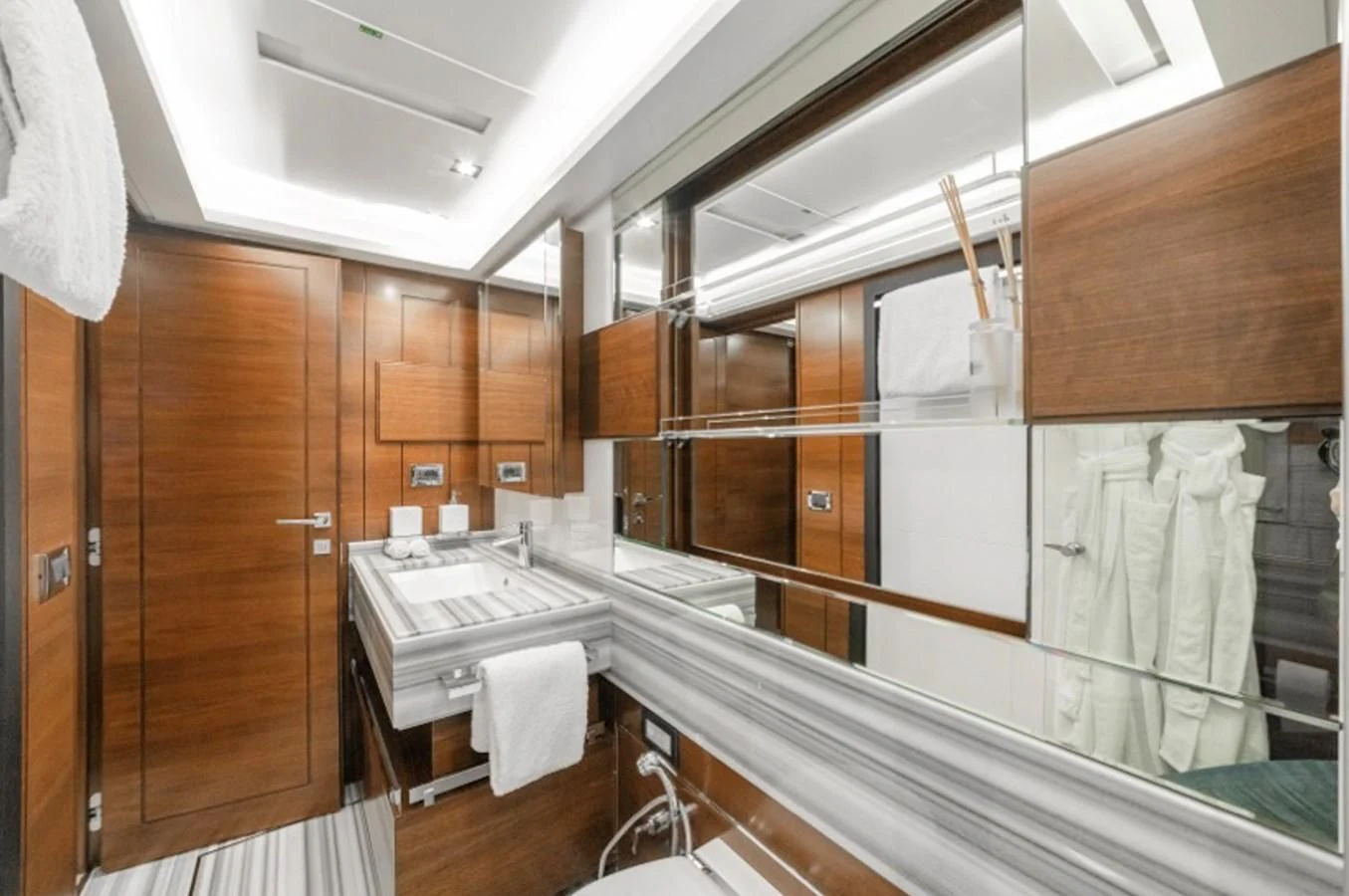 a bathroom with wooden cabinets aboard ADEL Yacht for Sale