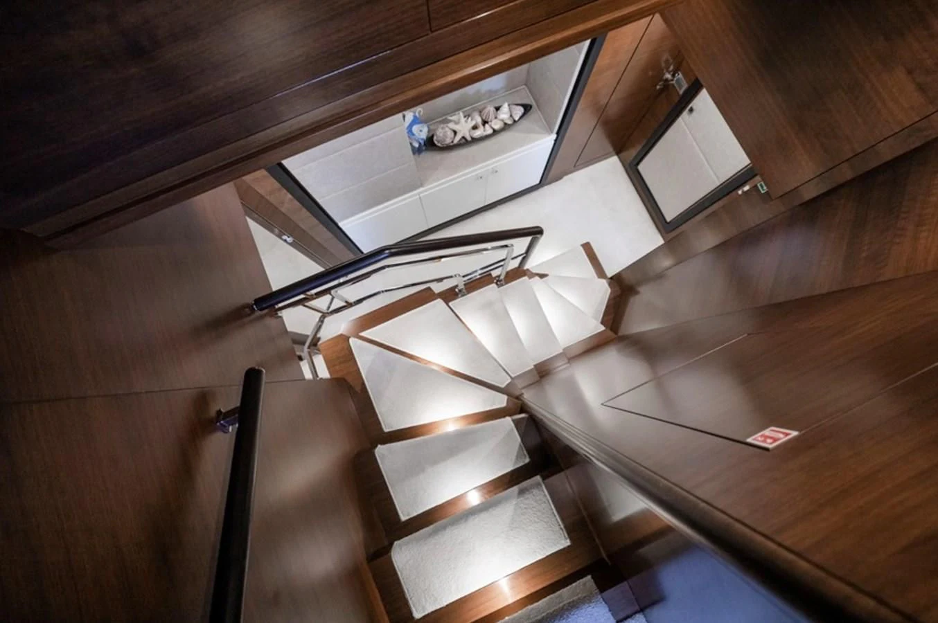 a white boat in a wooden room aboard ADEL Yacht for Sale