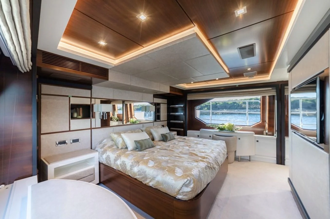 a bedroom with a bed and a table aboard ADEL Yacht for Sale