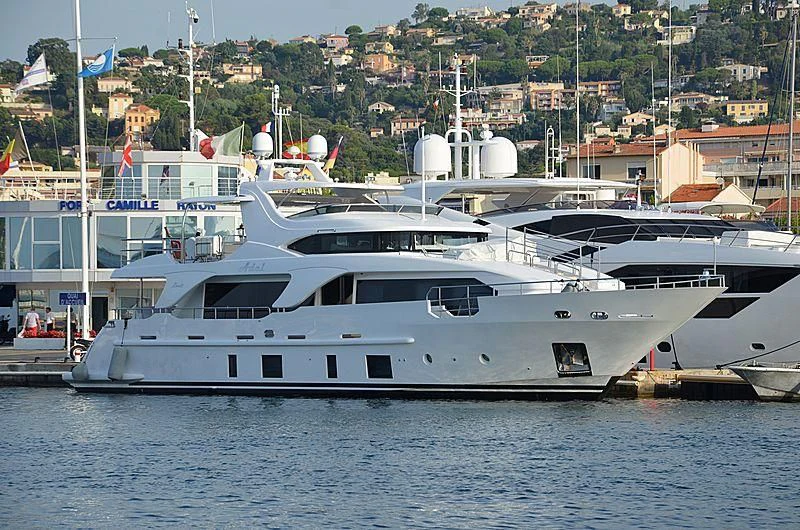 a large white boat in a harbor aboard ADEL Yacht for Sale