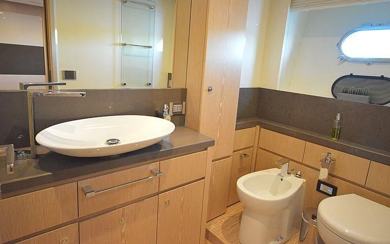 a bathroom with a sink and a toilet aboard DISPARATE Yacht for Sale