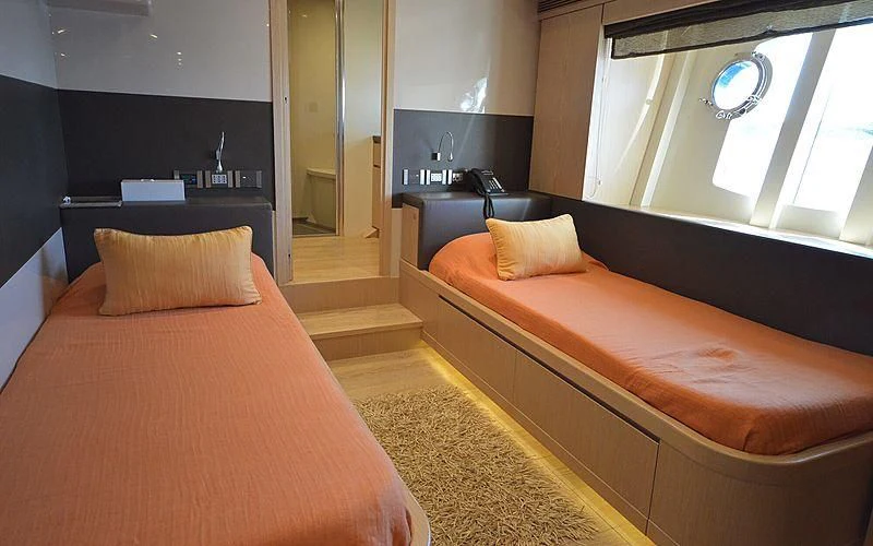 a room with a bed and a desk aboard DISPARATE Yacht for Sale