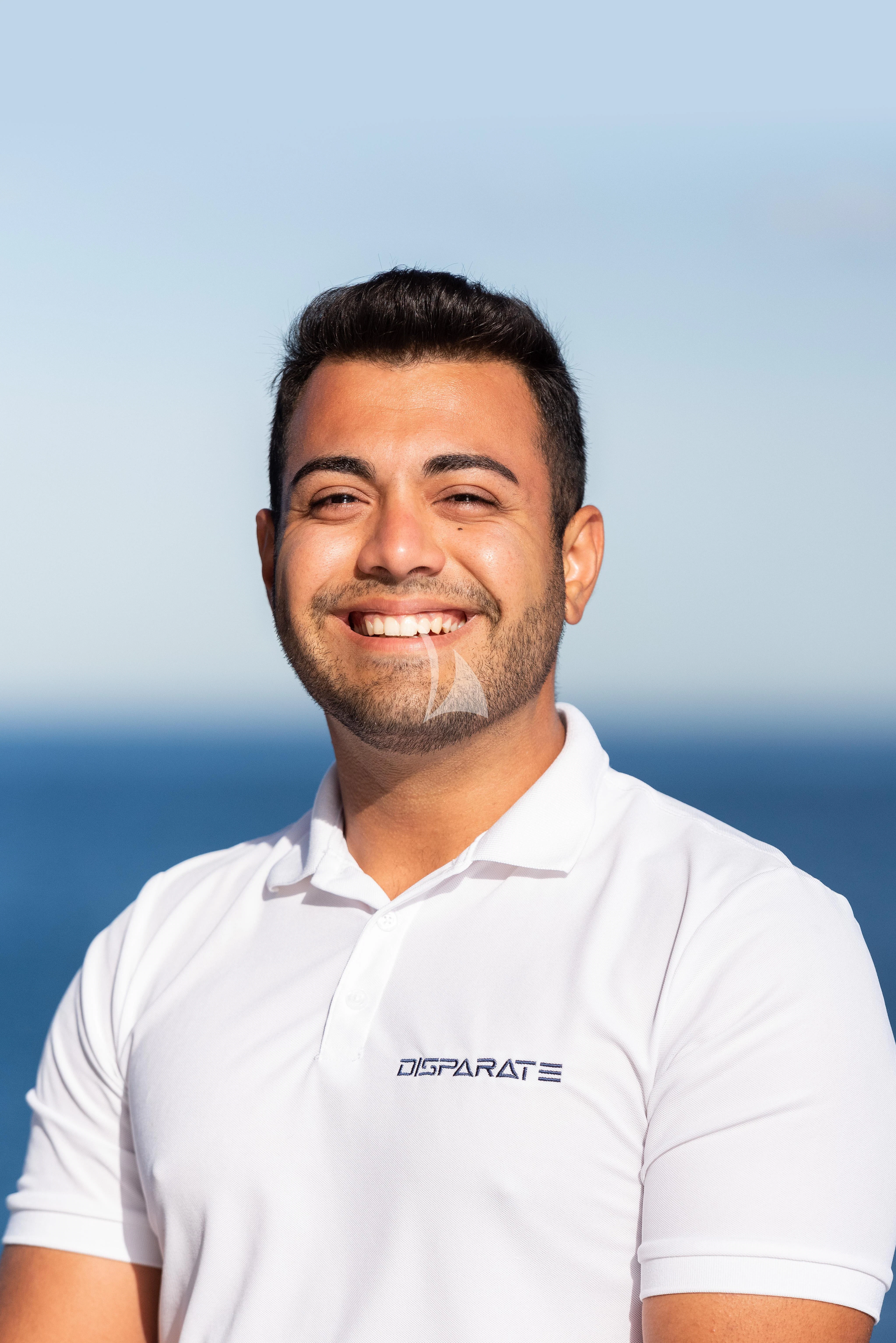 a man smiling for the picture aboard DISPARATE Yacht for Sale