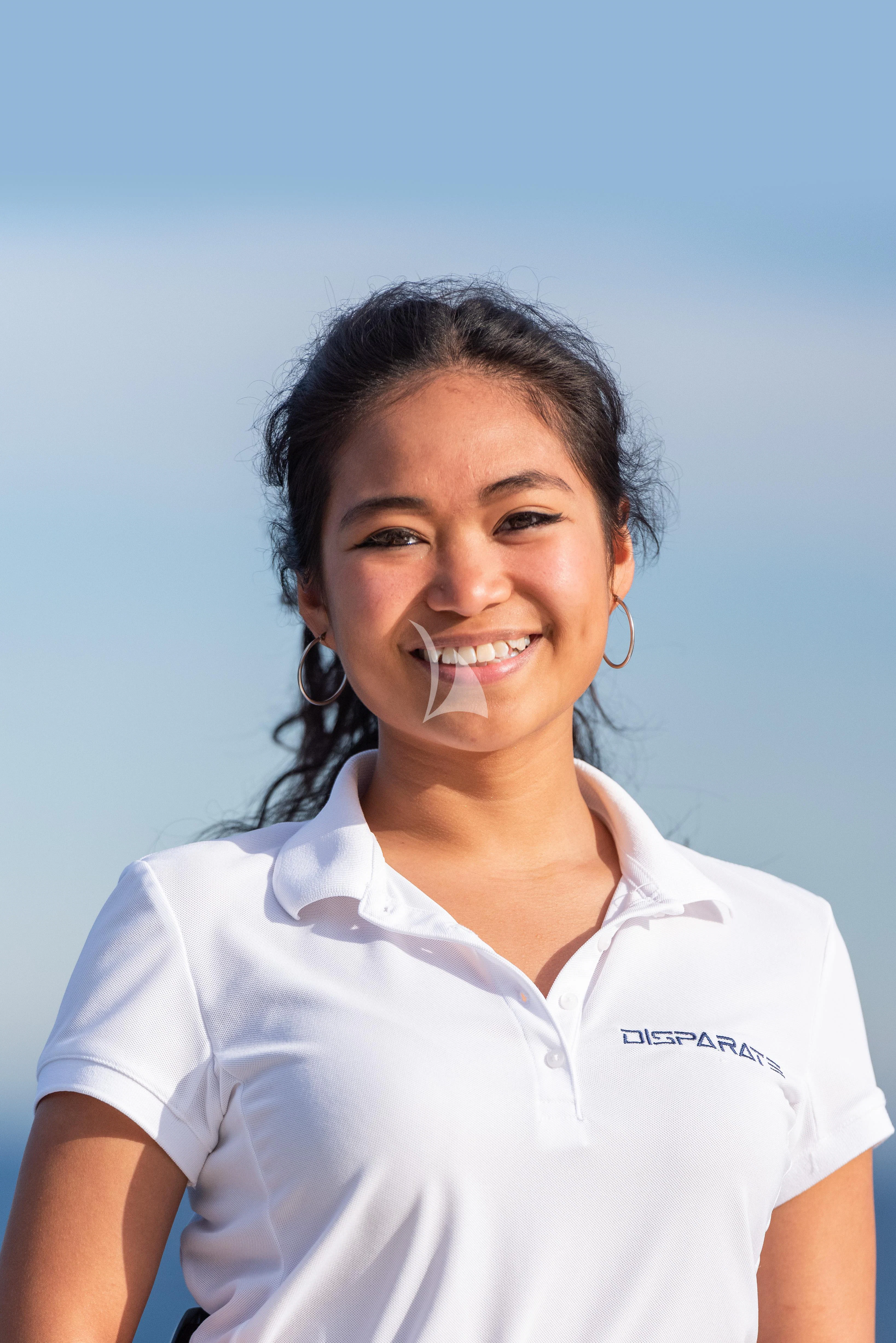 a woman smiling for the camera aboard DISPARATE Yacht for Sale