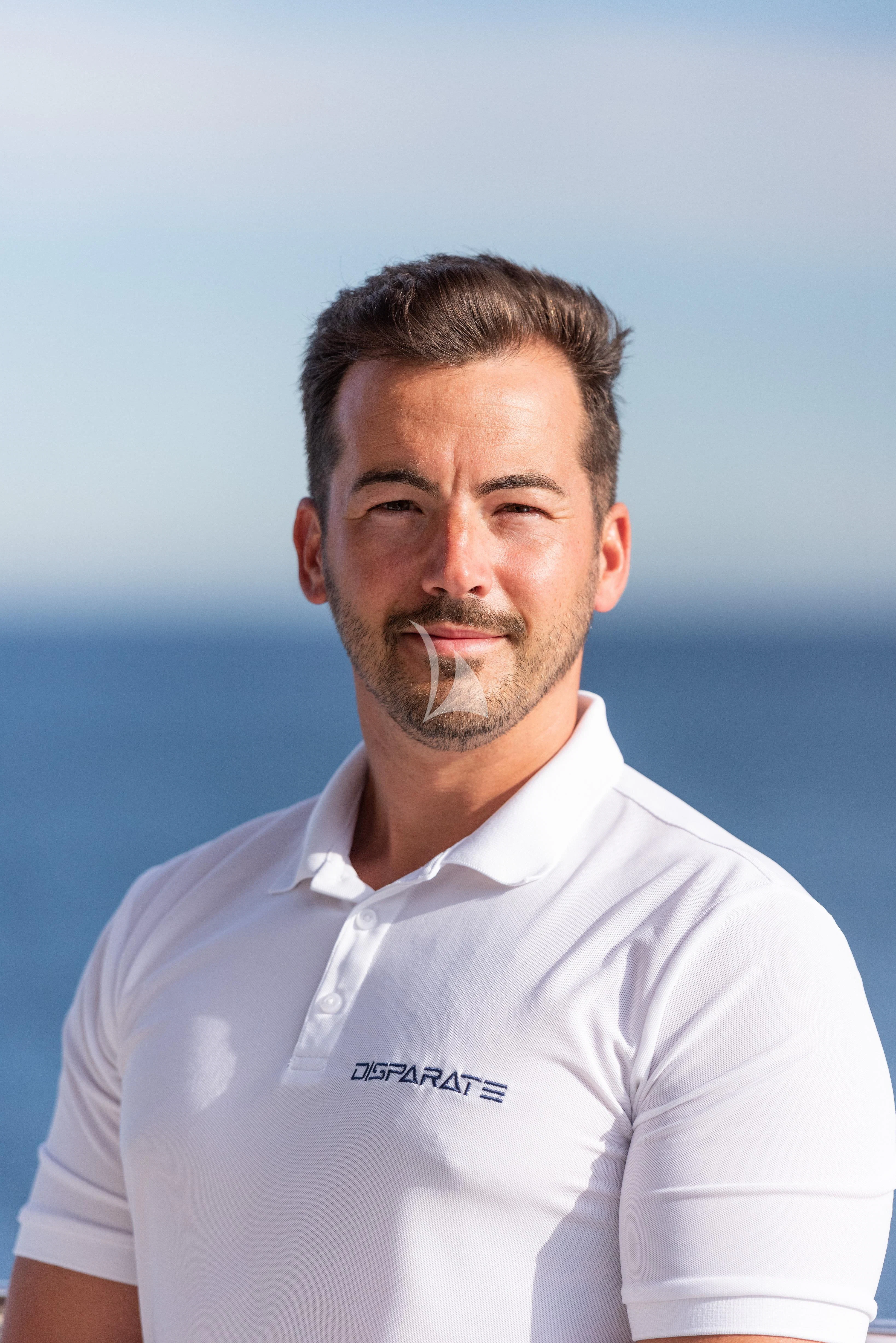 a man wearing a white shirt aboard DISPARATE Yacht for Sale