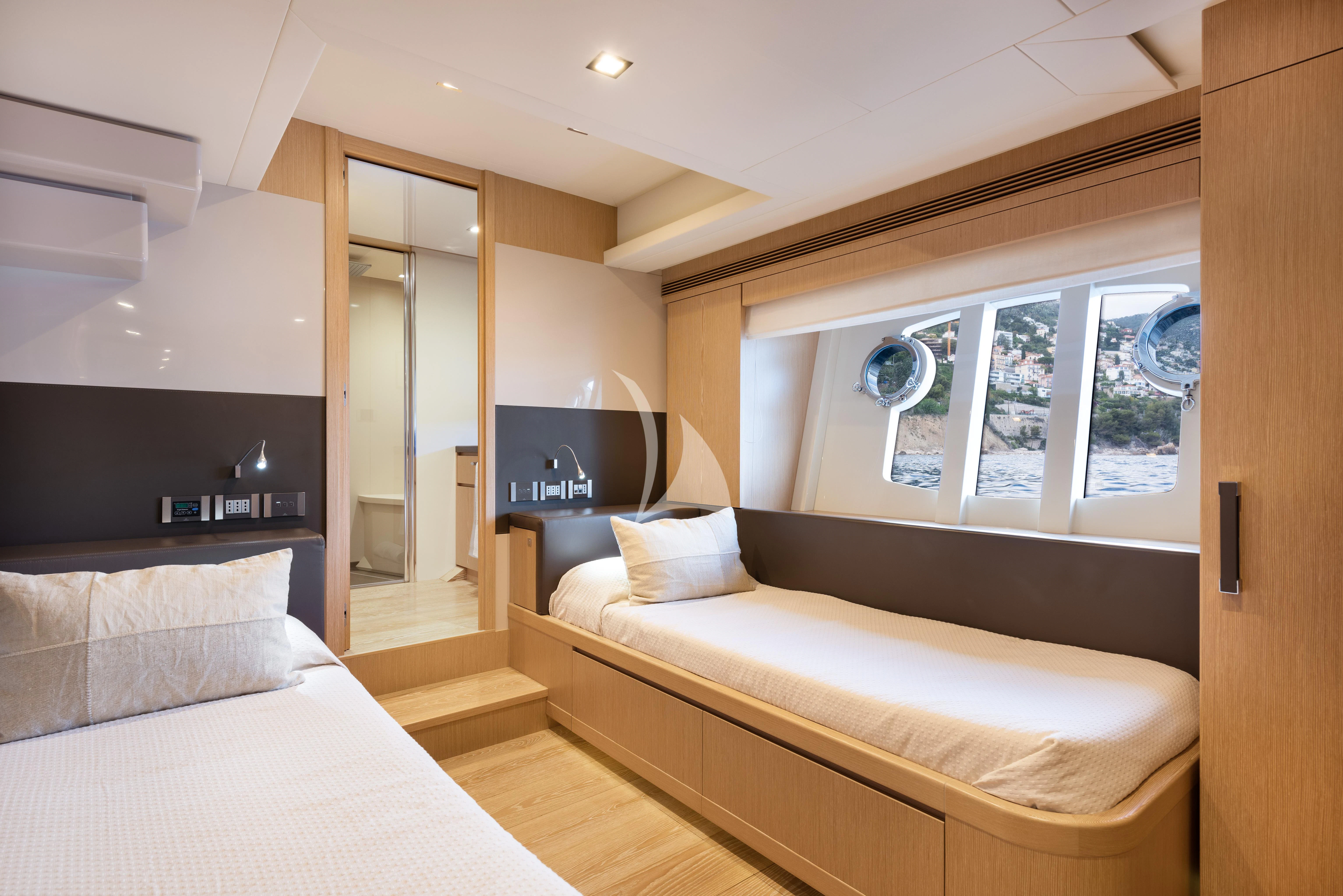 a bedroom with a bed and a tv aboard DISPARATE Yacht for Sale