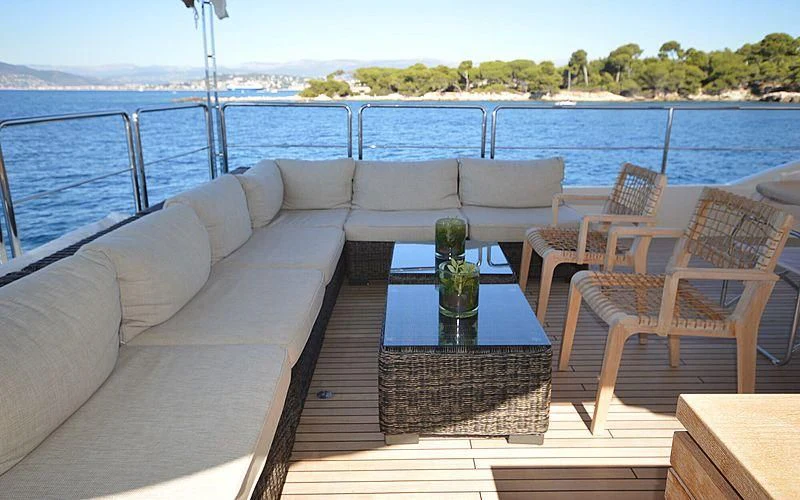 a table and chairs on a deck aboard DISPARATE Yacht for Sale