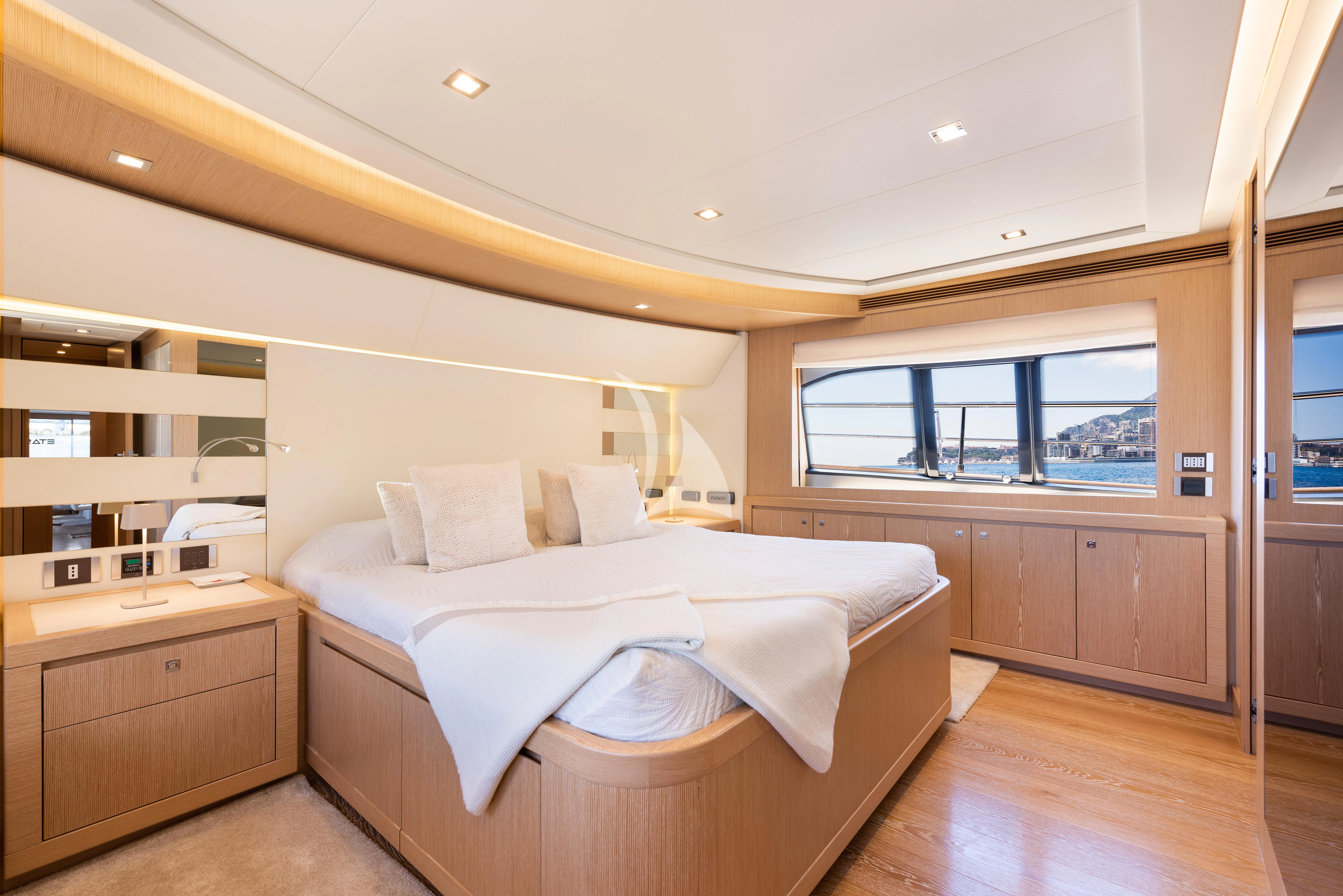 a bedroom with a bed and a window aboard DISPARATE Yacht for Sale